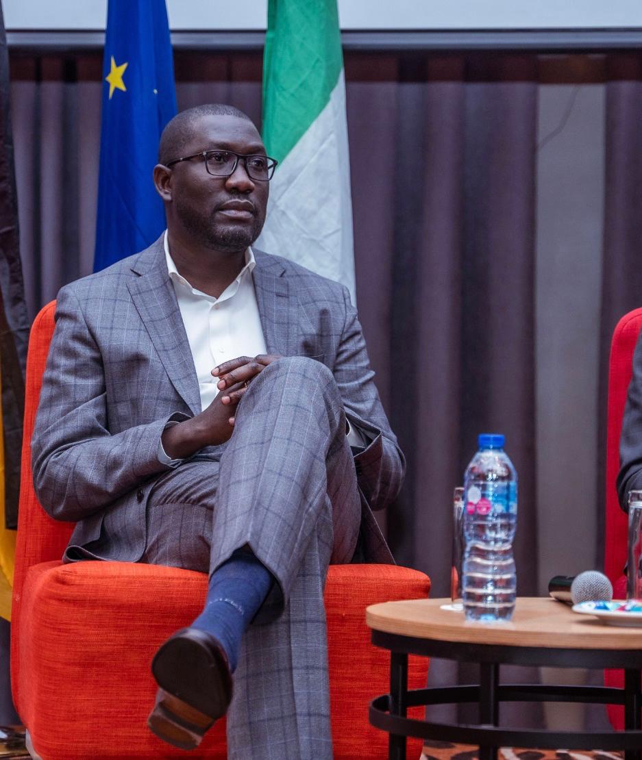 Seated on panel with EU and Nigerian flags